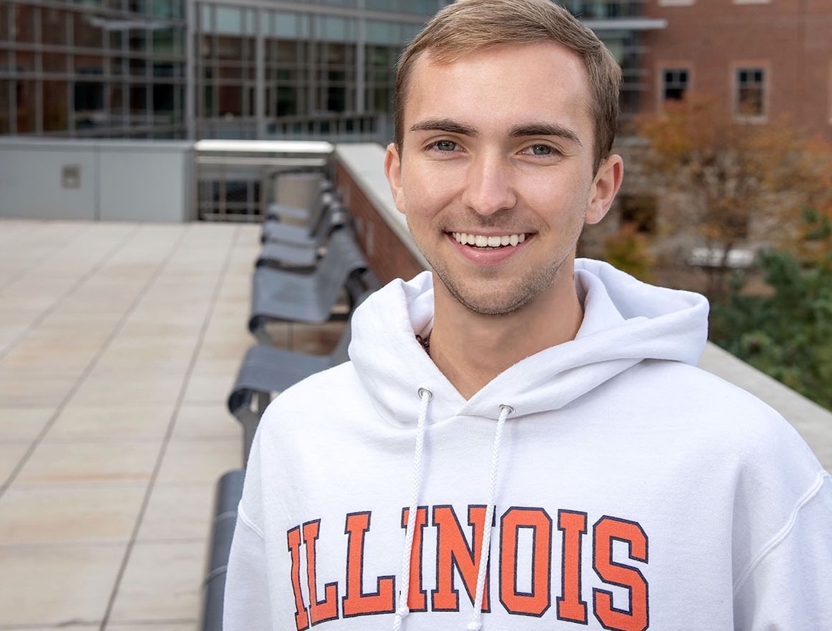 Nathan Ryan standing outside a building in a white Illinois hoodie.