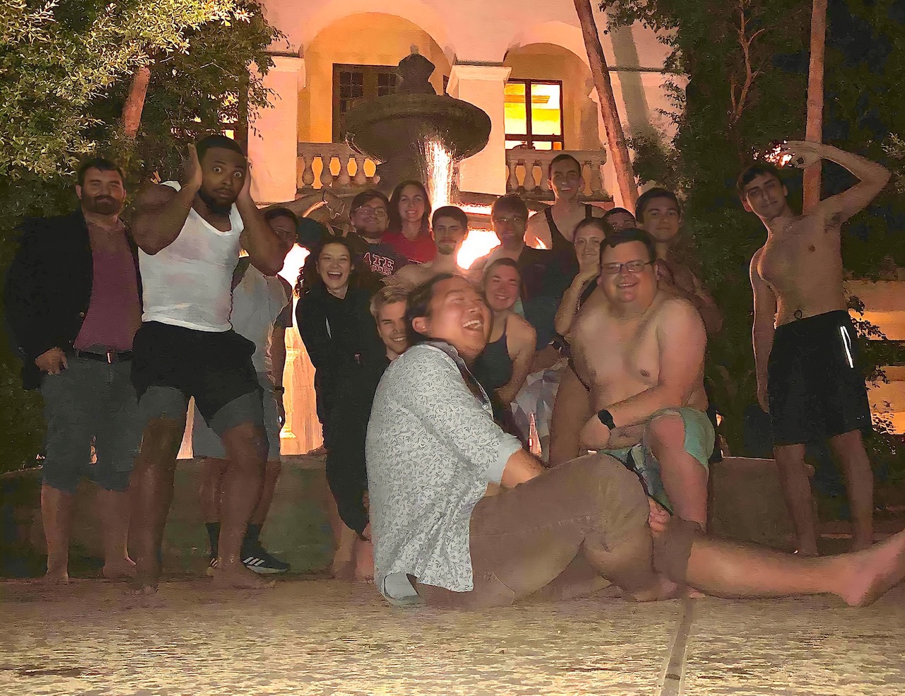 Group of students with Nathan Ryan at night standing in front of a fountain at the 2022 ANS Winter Meeting in Arizona.